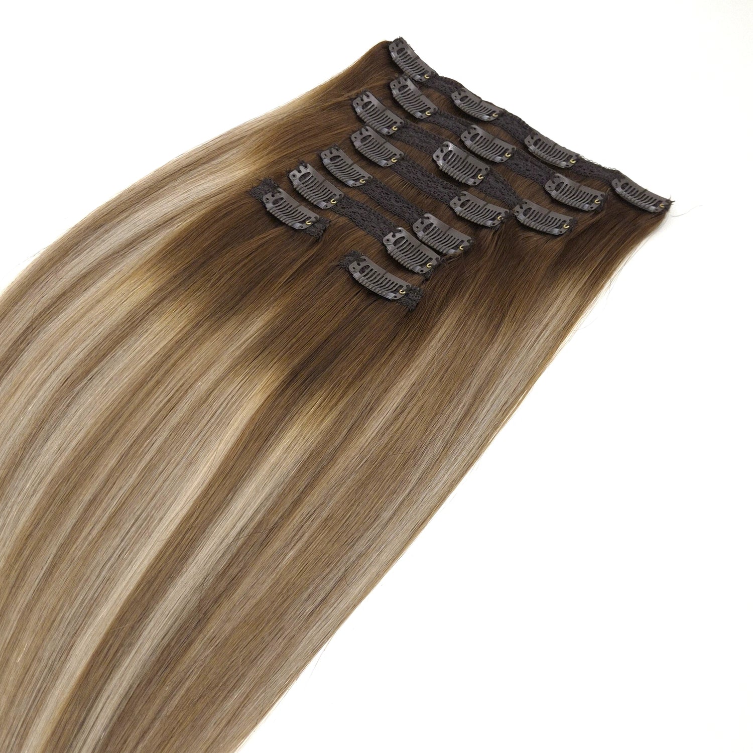 Set Clip in hair extensions van echt haar om je haar mee te verlengen in de kleur Honey met een donkere aanzet. Een prachtige Ombre tint met highlights. 